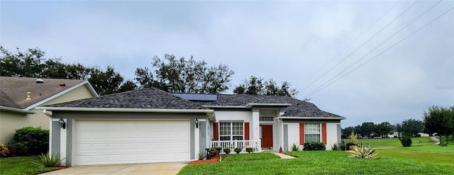 view of front of home featuring a front yard and a garage