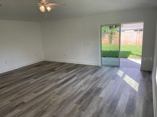 unfurnished room with ceiling fan and dark hardwood / wood-style floors