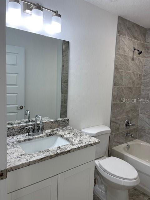 full bathroom with toilet, vanity, and washtub / shower combination