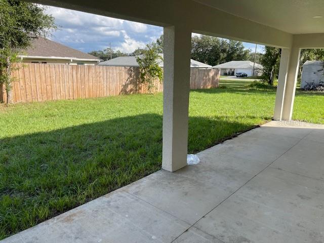 view of yard featuring a patio area and fence