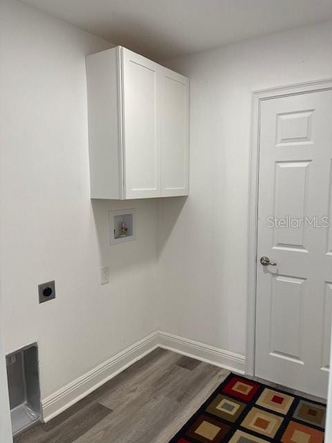 laundry area with hookup for a washing machine, cabinets, dark hardwood / wood-style floors, and hookup for an electric dryer