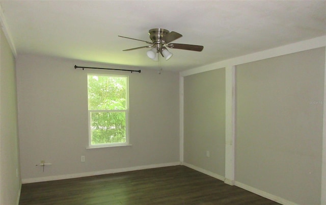 spare room with ceiling fan and dark wood-type flooring