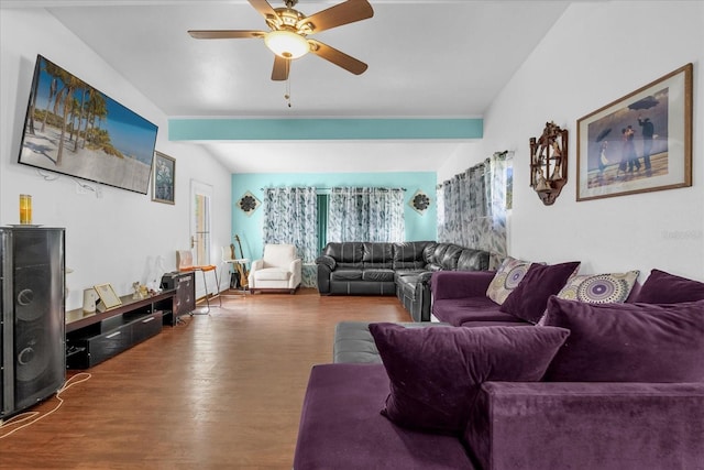 living room featuring ceiling fan, wood-type flooring, and vaulted ceiling with beams