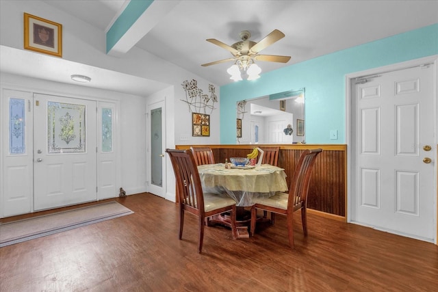 dining space with vaulted ceiling with beams, hardwood / wood-style flooring, and ceiling fan