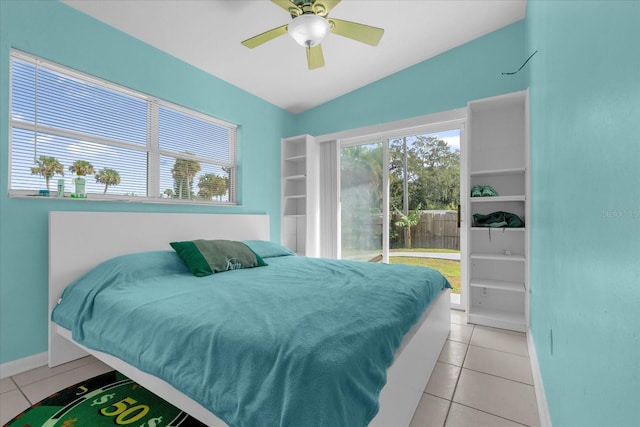 tiled bedroom with ceiling fan and lofted ceiling