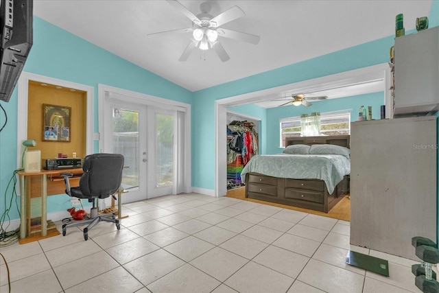 bedroom featuring french doors, ceiling fan, light tile patterned flooring, and multiple windows