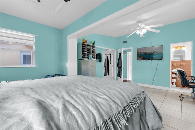 tiled bedroom with ensuite bath and ceiling fan