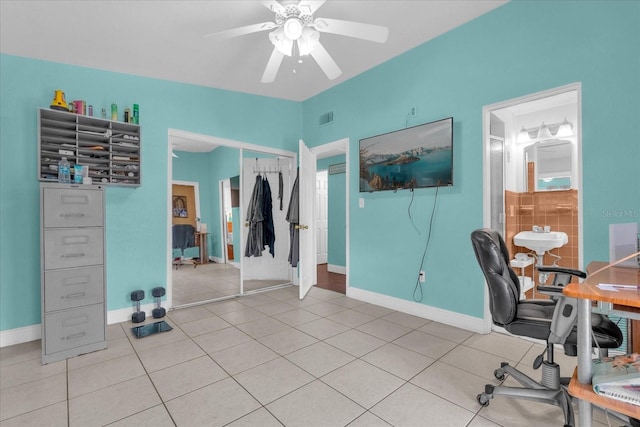 tiled home office featuring ceiling fan