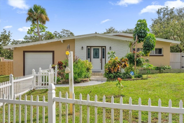 single story home featuring a front lawn and a garage