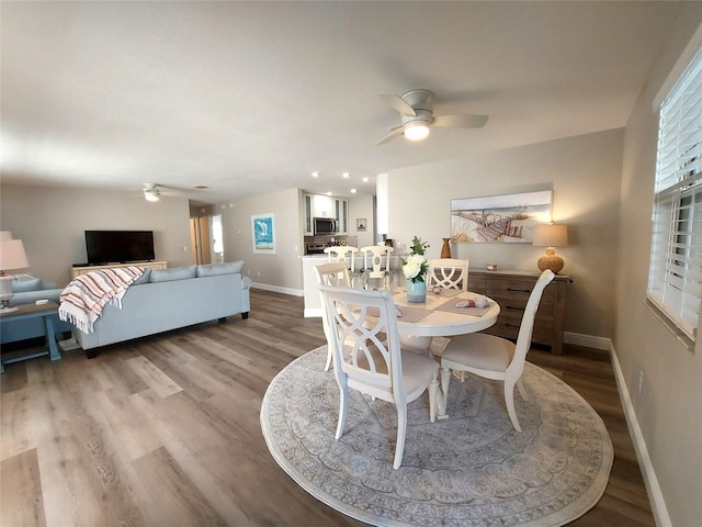 dining space with light hardwood / wood-style floors and ceiling fan