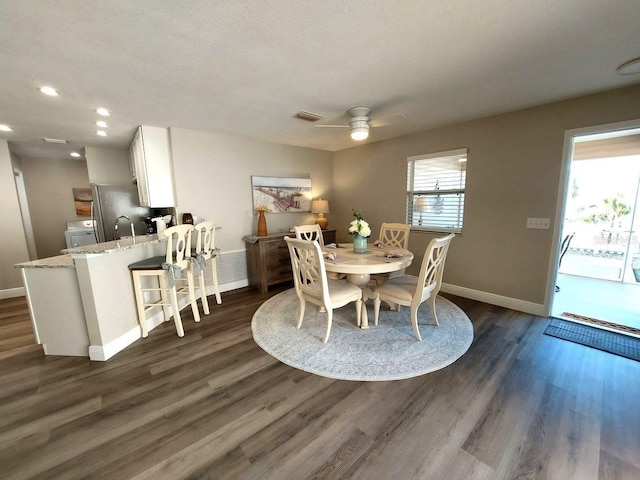 dining area featuring washer / dryer, a textured ceiling, dark hardwood / wood-style floors, and ceiling fan