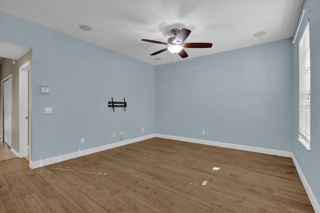 spare room with light hardwood / wood-style floors and ceiling fan