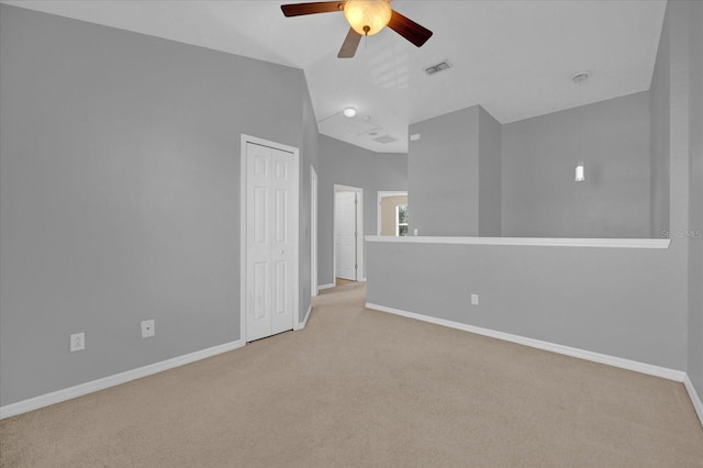 carpeted empty room featuring ceiling fan and lofted ceiling