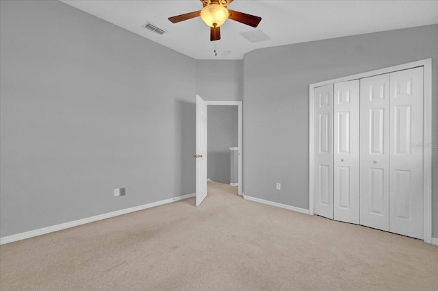 unfurnished bedroom featuring a closet, ceiling fan, and light carpet