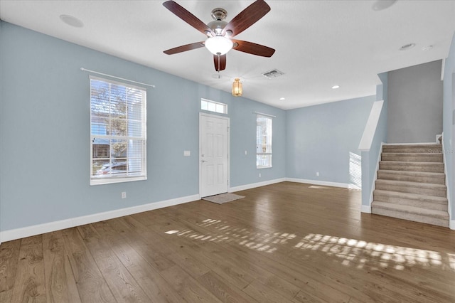 interior space with dark wood-type flooring, plenty of natural light, and ceiling fan