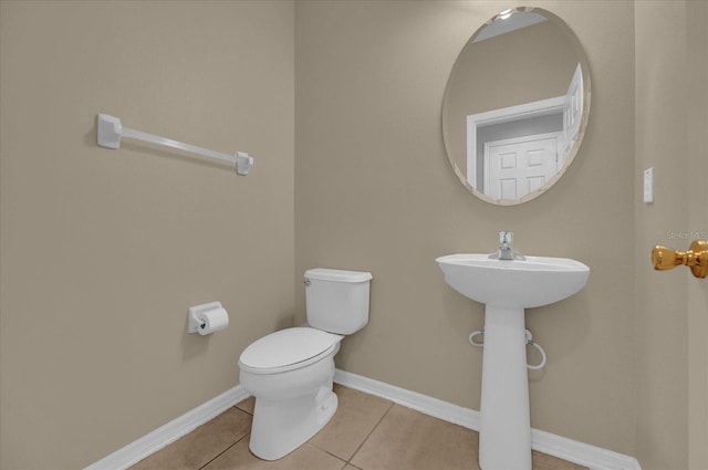 bathroom featuring toilet and tile patterned flooring