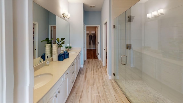 bathroom with vanity and a shower with shower door