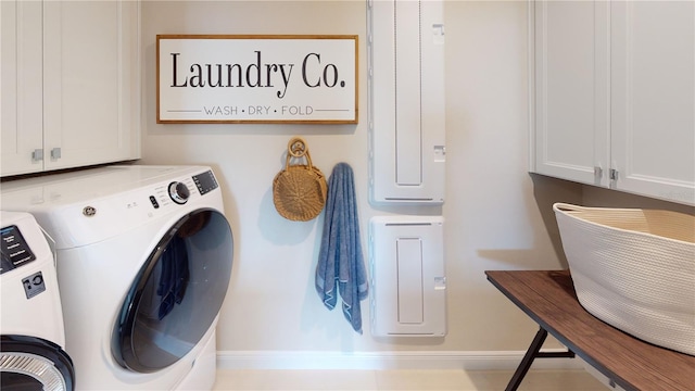 washroom featuring washer and dryer and cabinets