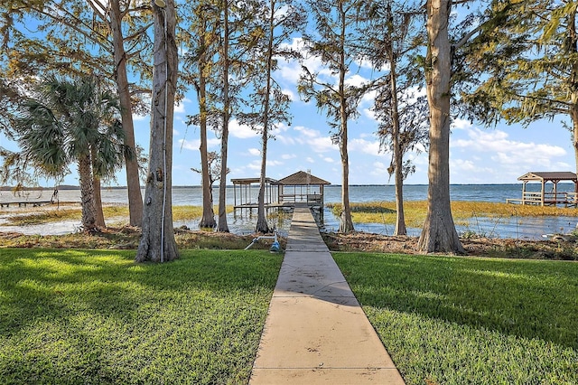 dock area featuring a yard and a water view