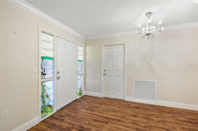 entryway featuring a notable chandelier, dark hardwood / wood-style floors, and ornamental molding