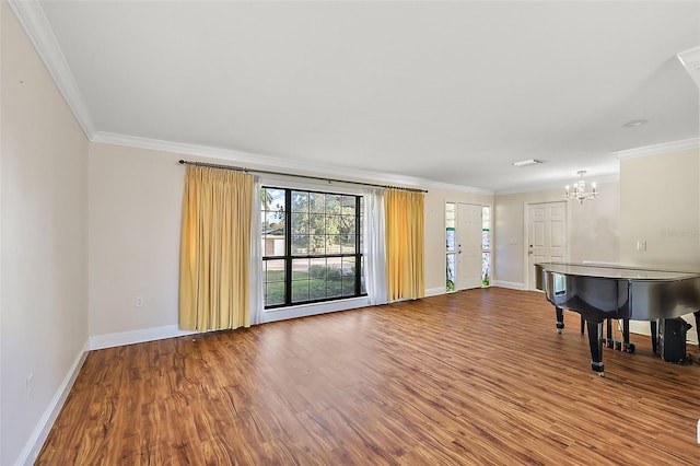 interior space featuring wood-type flooring, ornamental molding, and a chandelier