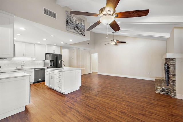 kitchen featuring white cabinets, a kitchen island with sink, appliances with stainless steel finishes, and hardwood / wood-style floors