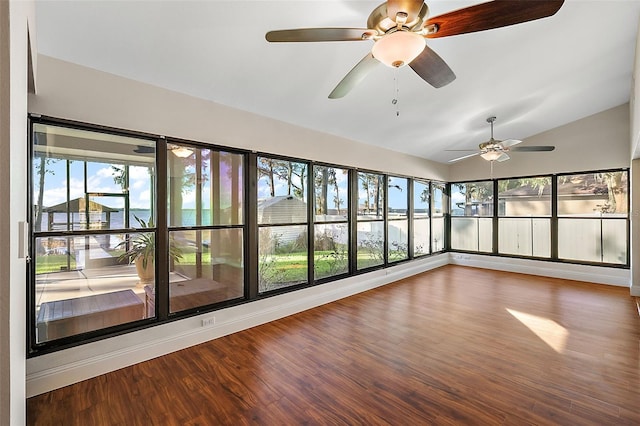 unfurnished sunroom with vaulted ceiling, a wealth of natural light, and ceiling fan