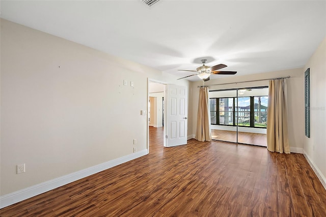 spare room featuring ceiling fan and dark wood-type flooring