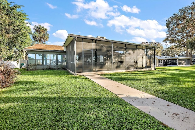 exterior space with a sunroom and a lawn