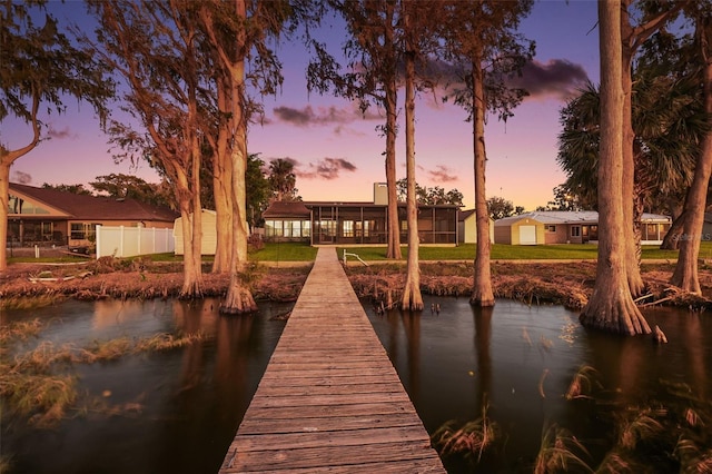 view of dock featuring a yard and a water view