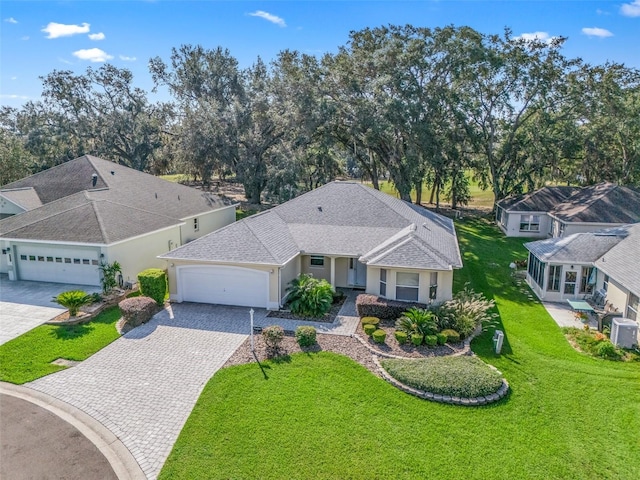 view of front of home with a front yard and a garage