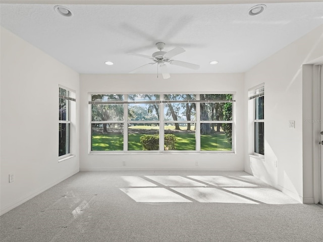 unfurnished room featuring ceiling fan and light colored carpet