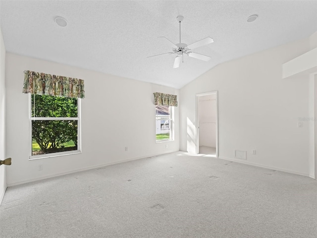 unfurnished room with lofted ceiling, plenty of natural light, light carpet, and ceiling fan