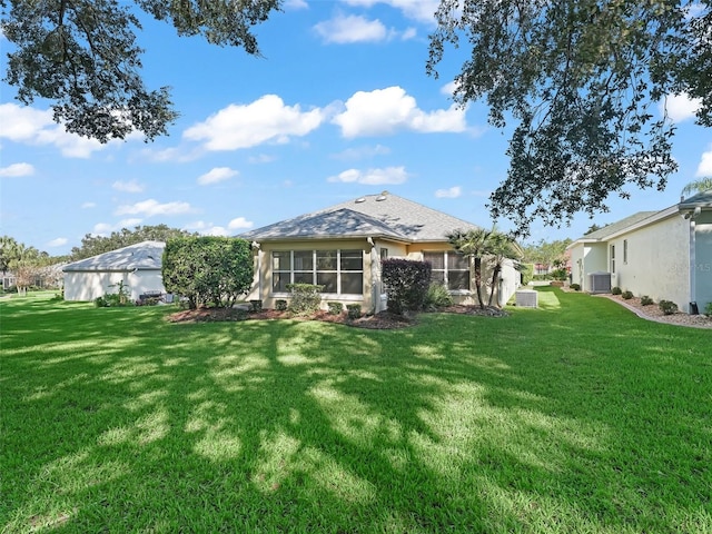 back of property featuring a lawn