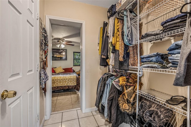 spacious closet with light tile patterned flooring and ceiling fan