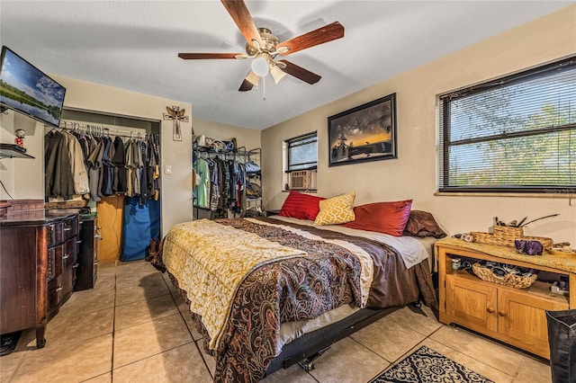 tiled bedroom with a closet, cooling unit, and ceiling fan