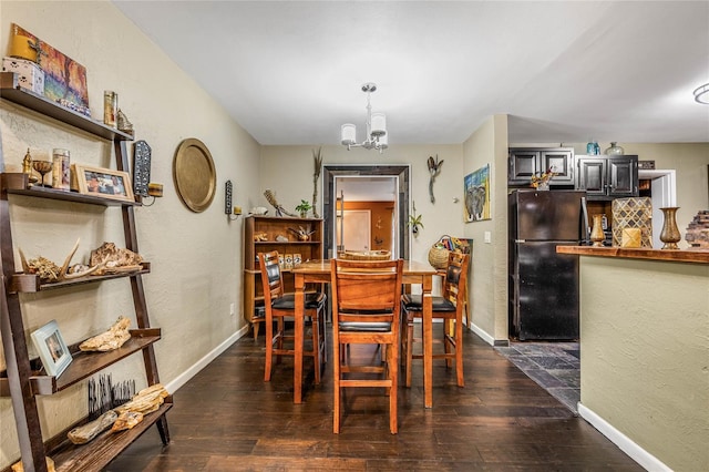 dining room with an inviting chandelier and dark hardwood / wood-style floors