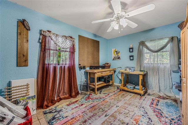 miscellaneous room featuring ceiling fan and light tile patterned floors