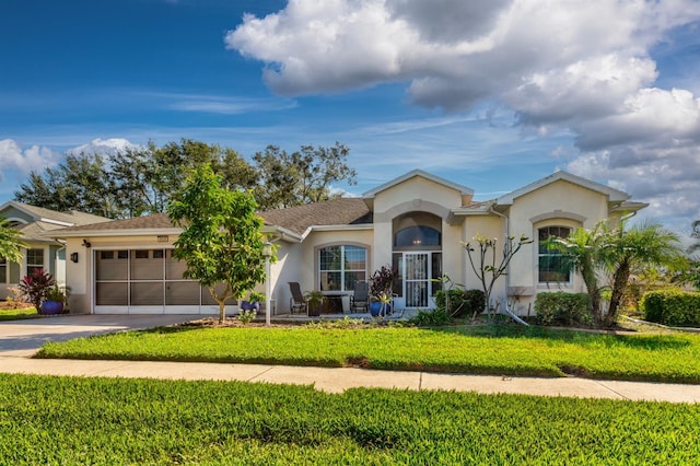 single story home with a front yard and a garage