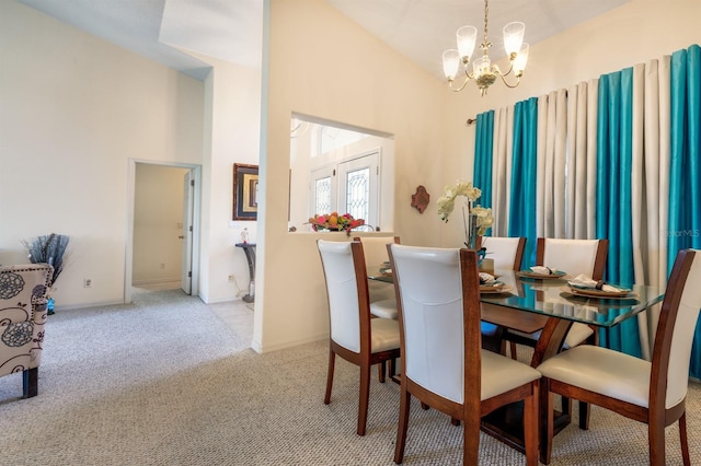 dining area with a notable chandelier, light carpet, and high vaulted ceiling