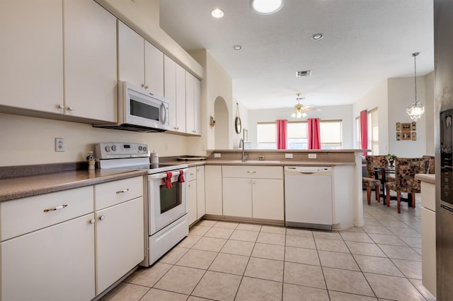 kitchen featuring pendant lighting, white appliances, kitchen peninsula, ceiling fan, and white cabinetry