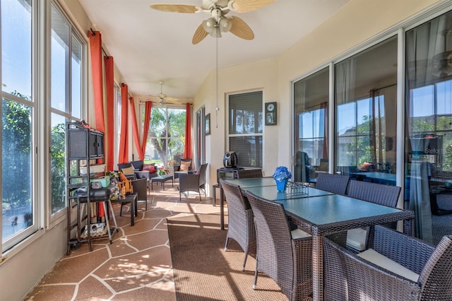 sunroom / solarium featuring ceiling fan