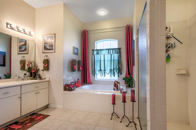 bathroom with tile patterned flooring, shower with separate bathtub, and vanity