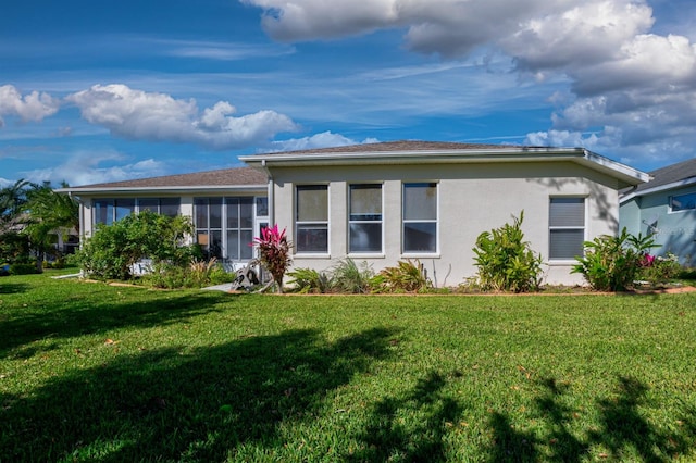 view of front of property with a sunroom and a front lawn