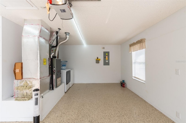 kitchen with electric panel, washing machine and dryer, and a textured ceiling