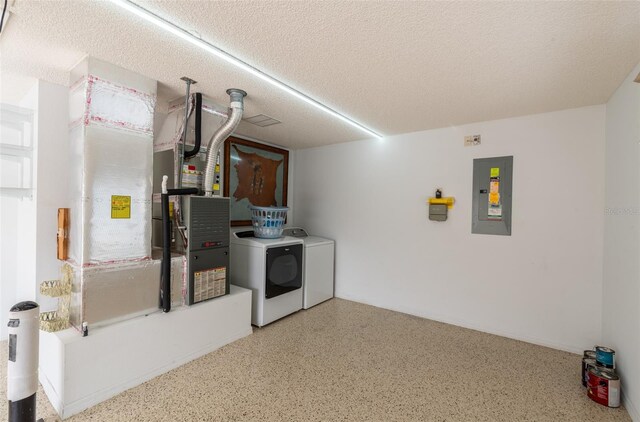 interior space featuring washer and dryer, electric panel, and a textured ceiling