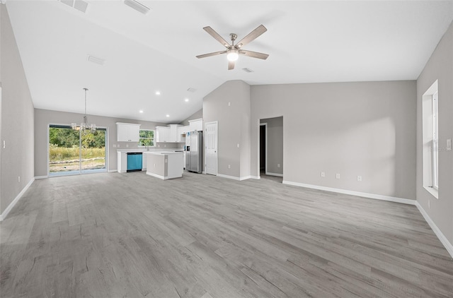 unfurnished living room with lofted ceiling, ceiling fan with notable chandelier, and light hardwood / wood-style floors