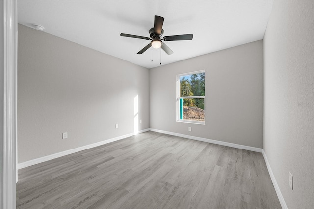 spare room with ceiling fan and light hardwood / wood-style flooring