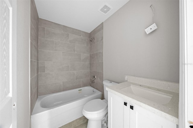 full bathroom featuring toilet, tiled shower / bath combo, and vanity