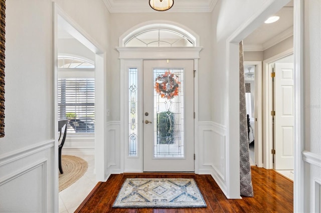 entryway with crown molding and dark wood-type flooring